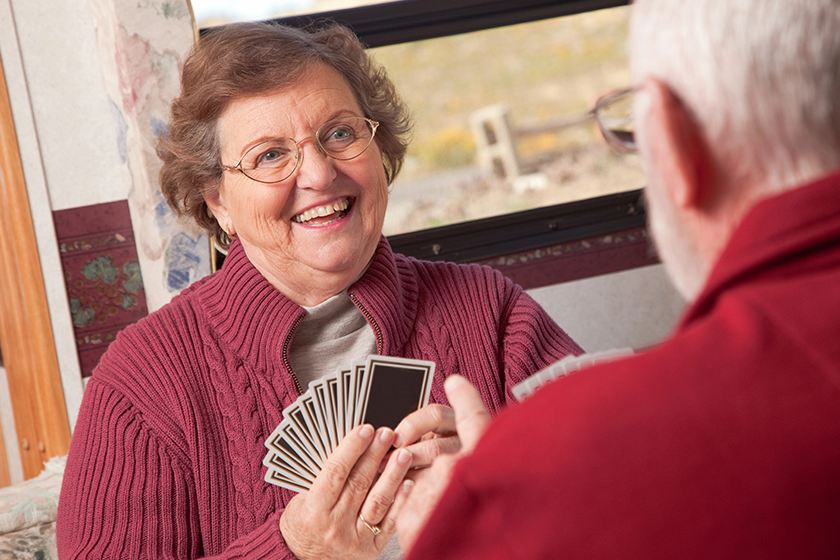 happy-senior-adult-couple-playing-cards